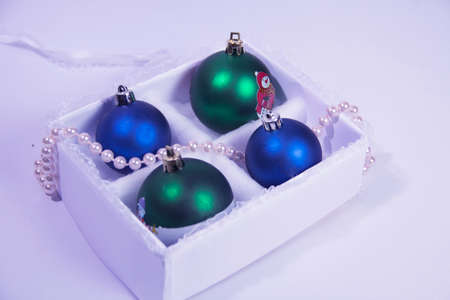The Christmas decoration on a white background in a beautiful package. The New Year's gifts with a sprig of spruceの写真素材
