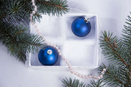 The Christmas decoration on a white background in a beautiful package. The New Year's gifts with a sprig of spruceの写真素材