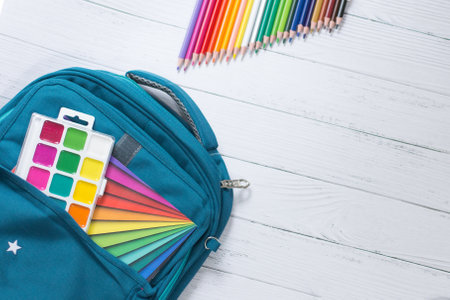The child's school supplies on a white background. Picking up the child for schoolの写真素材