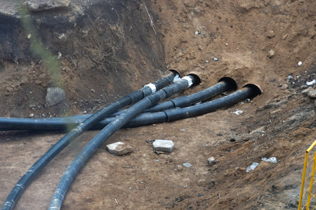 laying a new heating pipeline in a trench in the courtyard of a residential building in the city