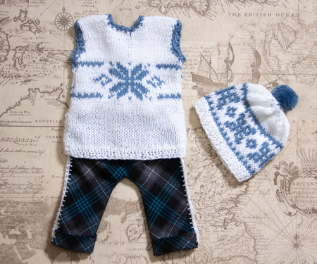 knitting patterns with knitting needles from woolen thread for a baby in light colors. knitting with needles according to a patternの写真素材