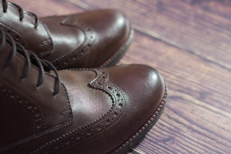new brown leather shoe with laces on dark backgroundの写真素材