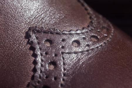 new brown leather shoe with laces on dark backgroundの写真素材