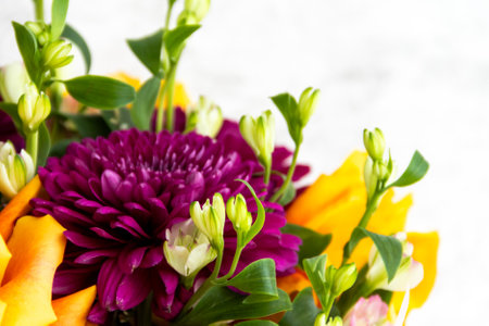 lilac dahlias with yellow roses in a bouquet on a light background close-up. bouquet of dahlias and roses on a light backgroundの写真素材
