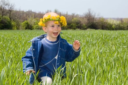 happy little boy run on the spring fieldの写真素材