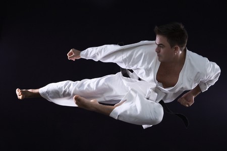 karate man champion of the world on black background studio shotの写真素材