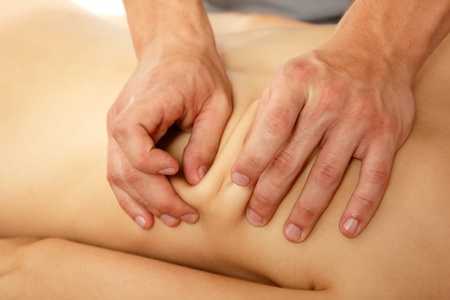 hands of masseur massaging woman young beautifulの写真素材