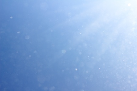 winter sky blue with snow and sun rays backgroundの写真素材