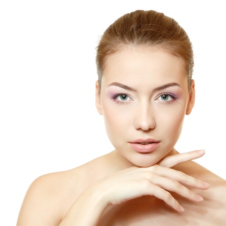 Woman beauty face closeup with clean skin and pink soft makeup. Isolated on white backgroundの写真素材