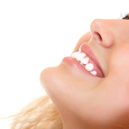 Beautiful smile of young fresh woman with healthy white teeth. Isolated over white background の写真素材