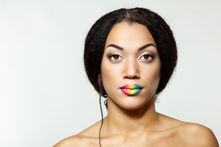 Beauty portrait of beautiful young mulatto fresh woman with rainbow lips, face and shoulders closeupの写真素材