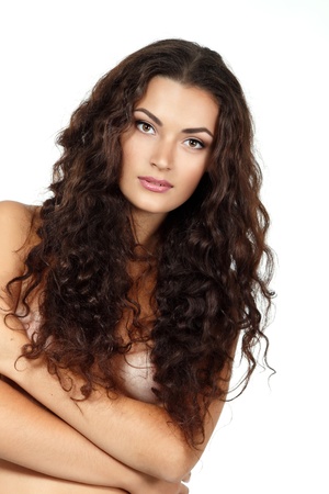 Beauty of young fresh woman with long brown healthy curly hair. Isolated on white background の写真素材