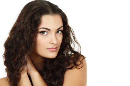 Beauty portrait of beautiful cheerful young fresh woman with long brown healthy curly hair. Isolated on white background の写真素材
