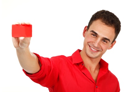 attractive friendly smiling confident young man showing red card in hand, over white backgroundの写真素材