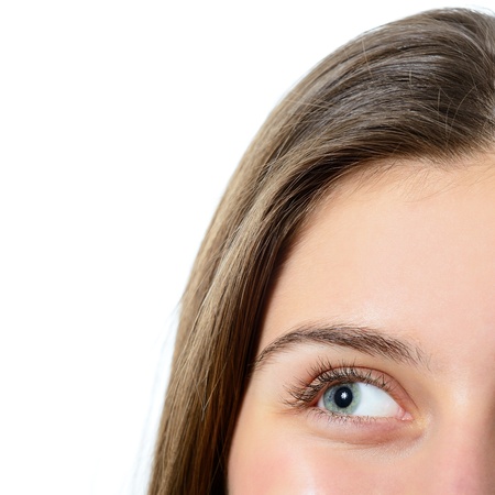 female green-blue eye closeup, looking left over whiteの写真素材