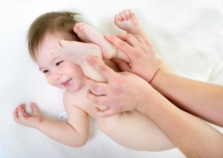 massage of cute smiling baby girlの写真素材
