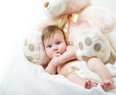 cute funny infant baby boy with big toy bear, beautiful kid's portrait closeupの写真素材