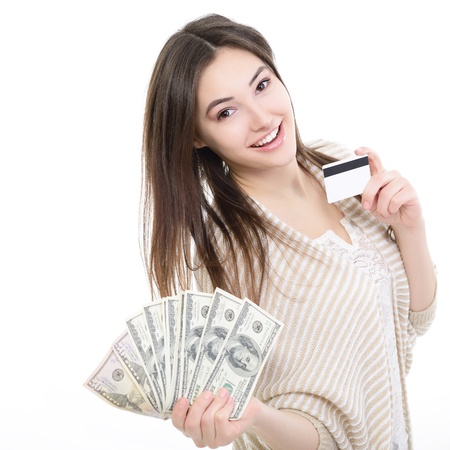Cheerful attractive young lady holding cash with plastic card and happy smiling over white backgroundの写真素材
