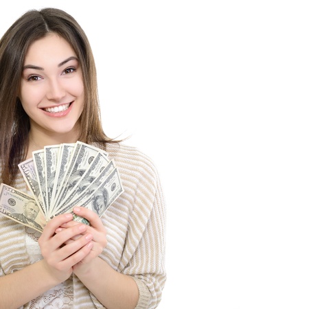 Cheerful attractive young smiling woman holding cash, over whiteの写真素材