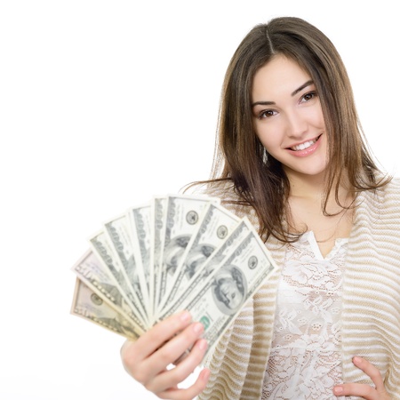 Cheerful attractive young woman holding cash and happy smiling over white backgroundの写真素材