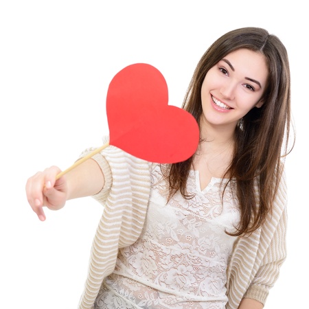 portrait of attractive happy smiling teen girl with red heartの写真素材