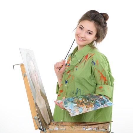 Girl painter drawing portrait with oil paints,  professional painter at work over white bacgroundの写真素材