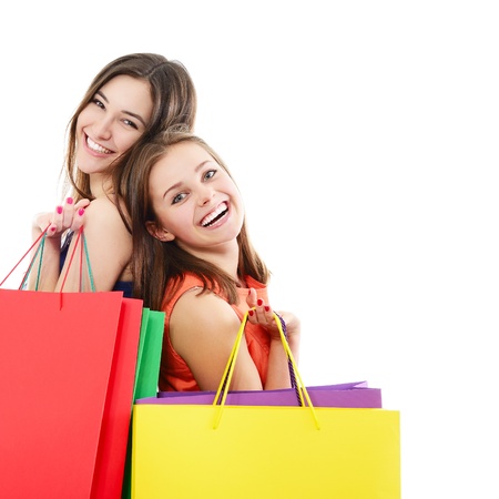 beautiful happy teen girls with colored shopping sale bags over whiteの写真素材