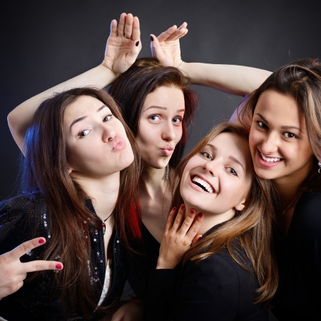 fashionable attractive happy party teen girls have fun, over black backgroundの写真素材
