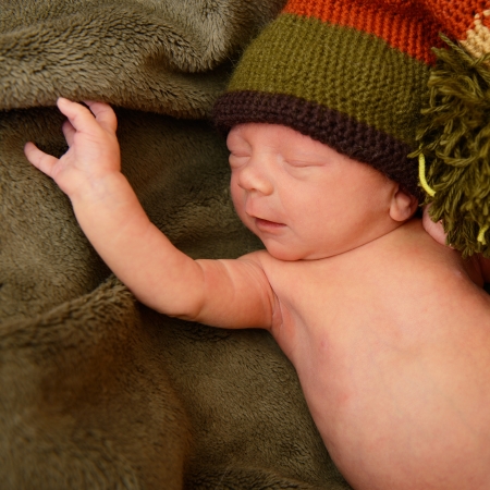 newborn baby, cute sleeping infant in green soft plaidの写真素材