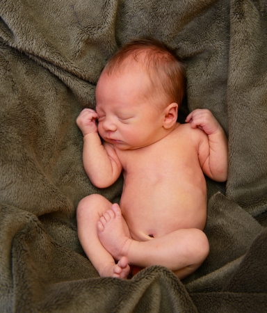 newborn baby, cute sleeping infant in green soft plaidの写真素材