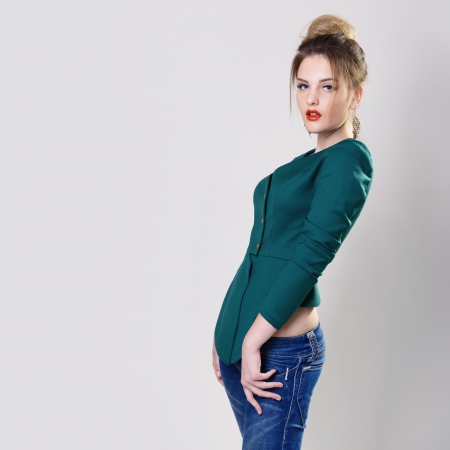fashion girl, portrait of young glamour luxury fashionable woman in green jacket and blue jeansの写真素材