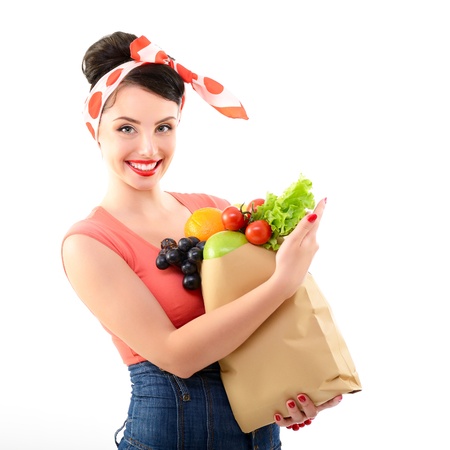 Pinup girl with food bag, portrait of young happy sexy woman in pin-up style, over whiteの写真素材