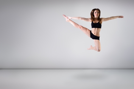 young beautiful dancer teen girl dancing and jumping, studio seriesの写真素材