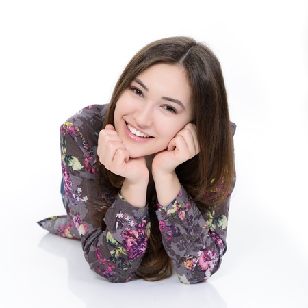 full length portrait of attractive teen girl looking at camera over whiteの写真素材