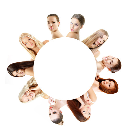 Group of very beautiful girls redheaded, blond and brumette, healthy faces closeup over white with empty round insideの写真素材