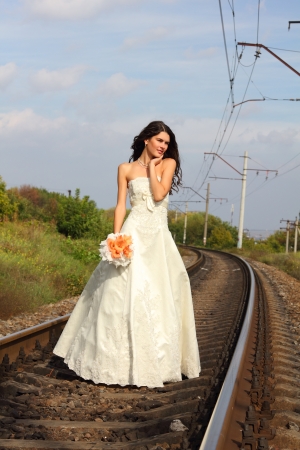 beautiful young bride on railway, summertimeの写真素材