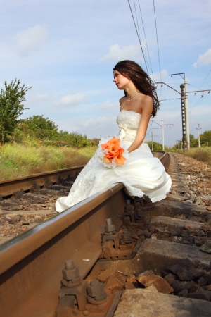 beautiful young bride on railway, summertimeの写真素材