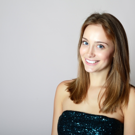 Portrait of attractive smiling girl, Beauty portrait of young woman with beautiful healthy face and big blue eyes  looking at cameraの写真素材