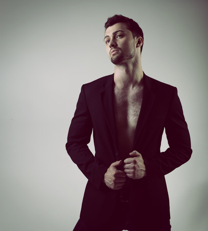 Portrait of handsome sexy young man over blackの写真素材