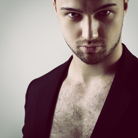Portrait of handsome young man over blackの写真素材