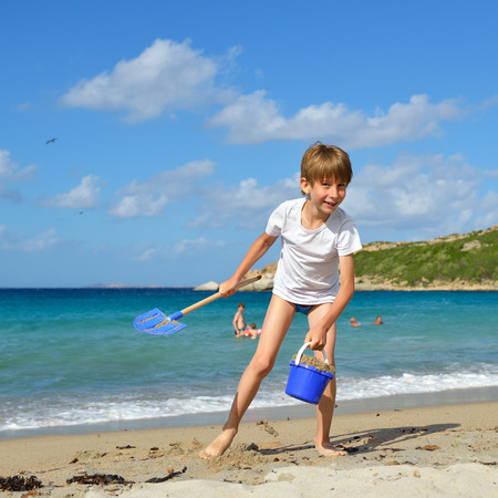 Child boy playing on the beachの写真素材