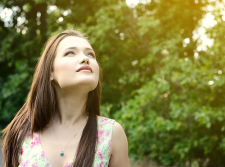 Fresh young beautiful woman. Portrait of girl summer outdoor, image toned.の写真素材
