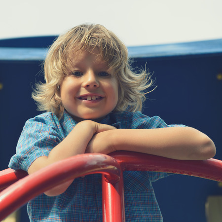 Cute young boy playing on playground. の写真素材