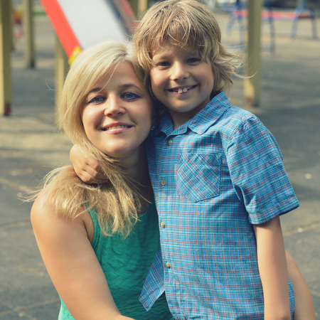 Portrait of happy mother and son in summer park, outdoor, tonedの写真素材