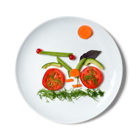 plate with bicycle make of vegetables. vegetarian food.の写真素材