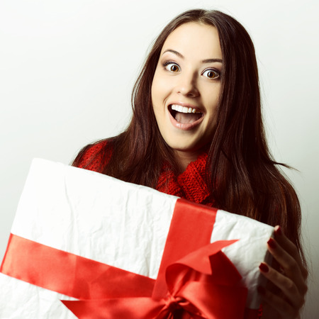 Xmas excited girl holding gift box surprised, tonedの写真素材