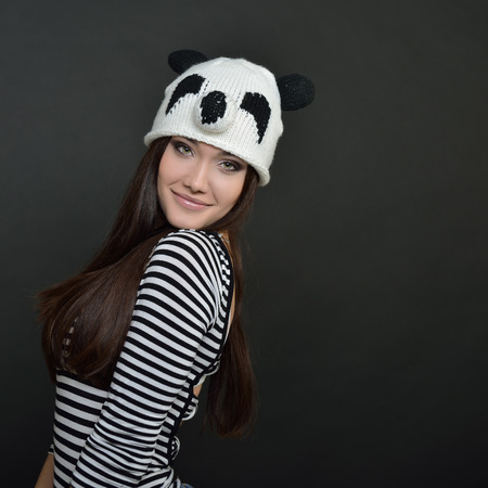 Glamour portrait of beautiful woman model with fresh daily makeup and funny hand made hat. Fashion female portrait.の写真素材