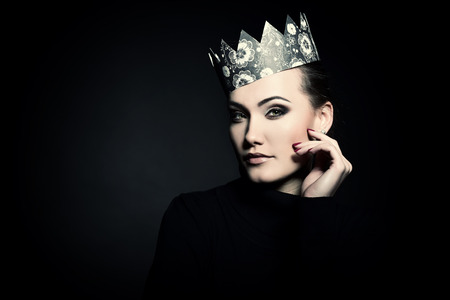 Glamour portrait of beautiful woman model with fresh daily makeup and crown. Fashion female portrait, image toned.の写真素材