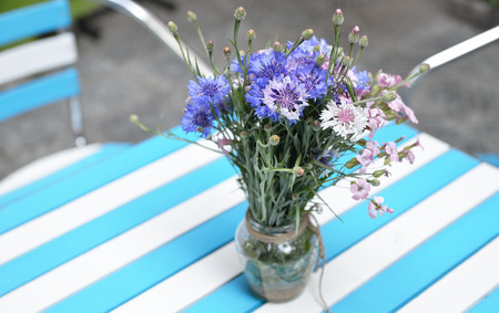 table with fresh wild flowers in cafe