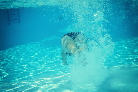 woman swimming underwater in water pool, image tonedの写真素材